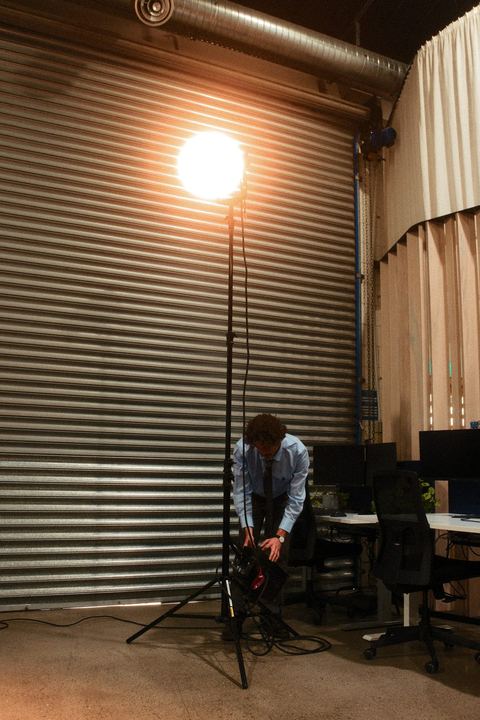 A film light glowing in front of a roller door on set
