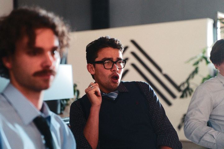 Two band members in shirts and ties between takes